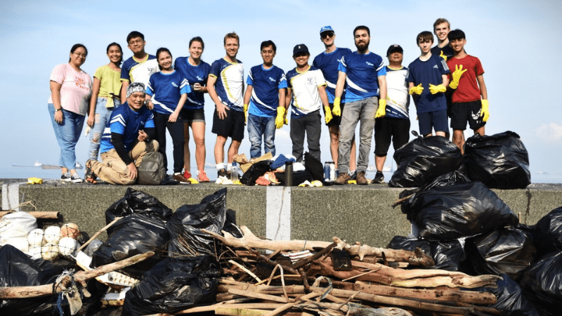 Haskoning colleagues in Manila taking part in a World Cleanup Day activity, standing with collected waste and debris after a coastal cleanup effort.