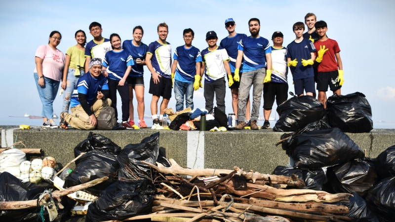 Haskoning colleagues in Manila taking part in a World Cleanup Day activity, standing with collected waste and debris after a coastal cleanup effort.