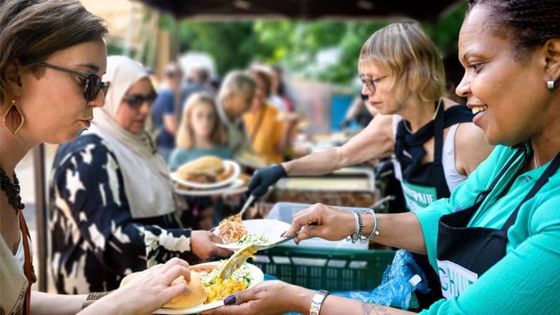 People enjoying food together in the Participation Kitchen