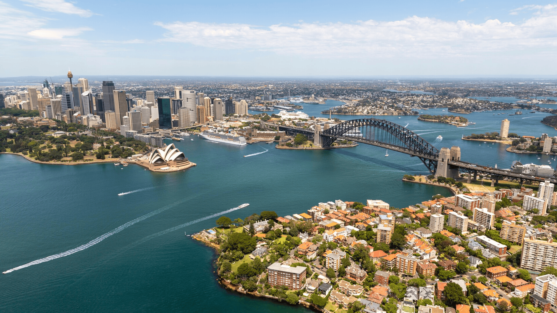 A rotating aerial view of Sydney, Brisbane, and Newcastle, showcasing Australia’s harbour cities and urban landscapes.