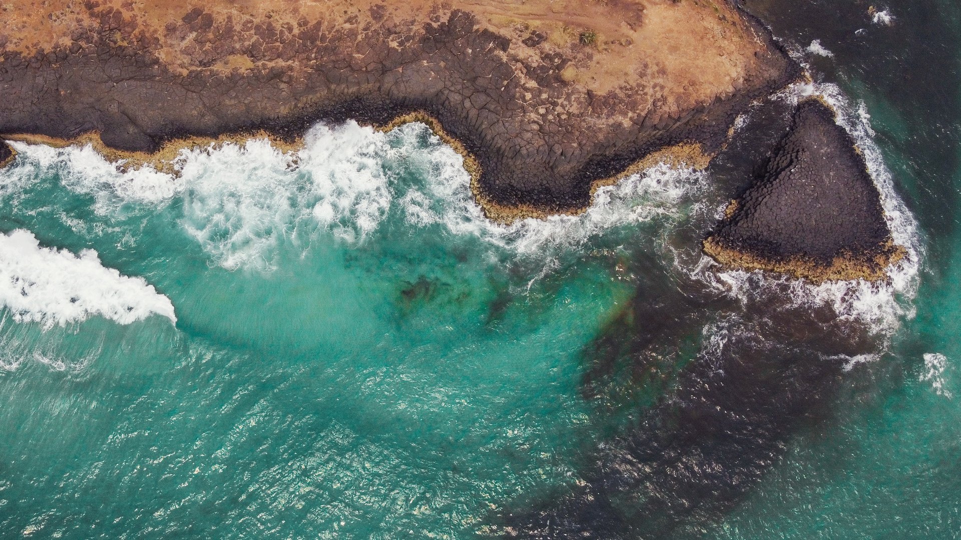 Water in waves next to a clif