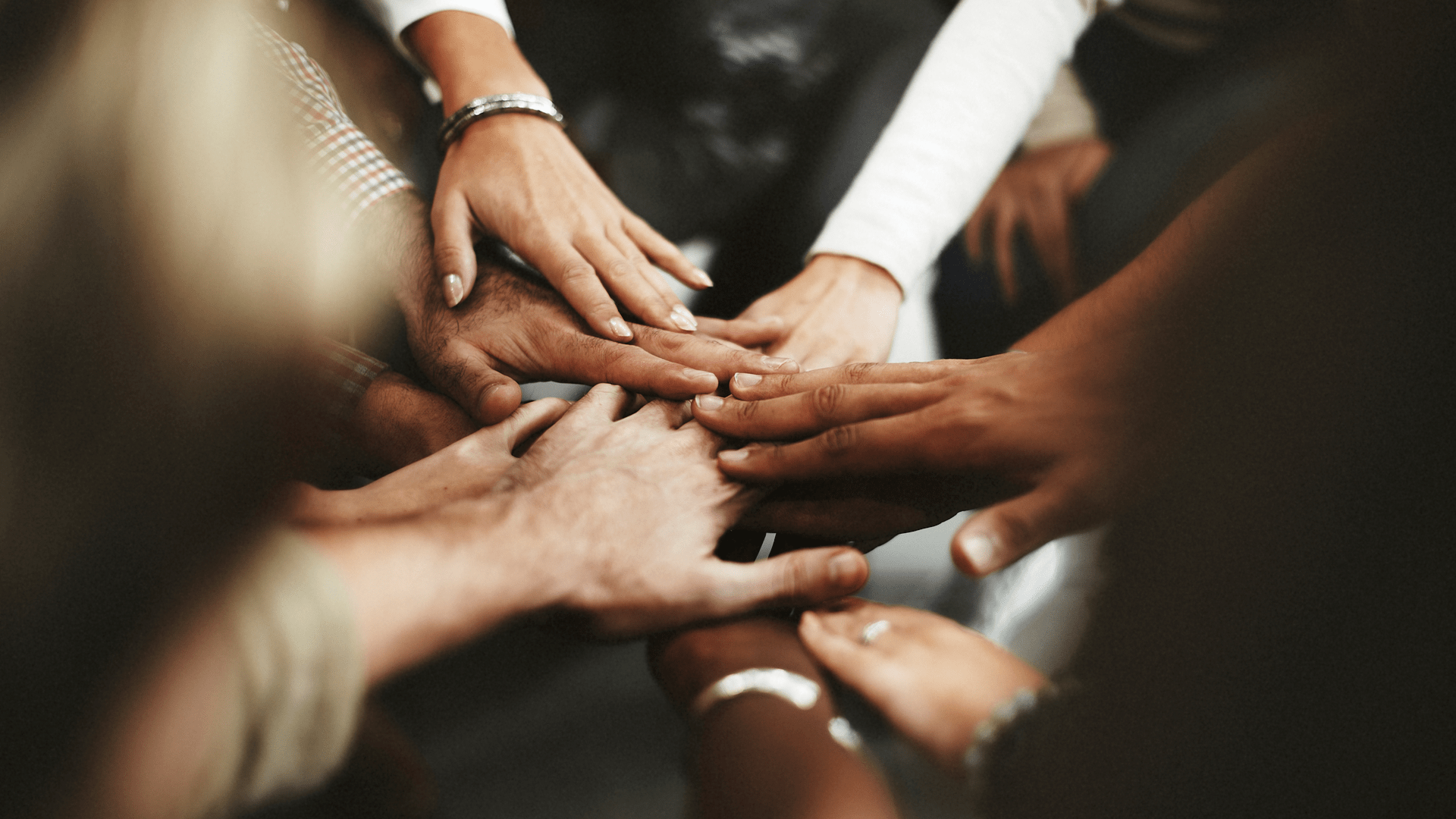 A group of people showing solidarity with hands