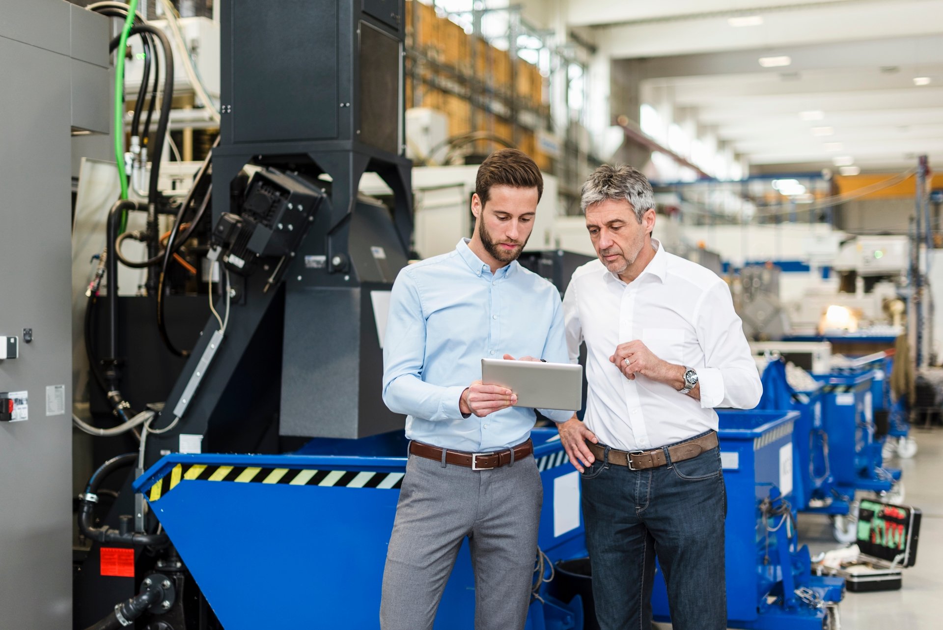 Industrial project team reviewing digital models and feasibility data on large screens in a modern workspace, symbolizing strategic planning and investment analysis.