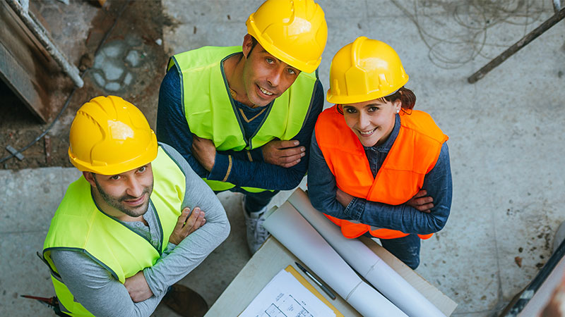 3 workers in construction with safety gear.
