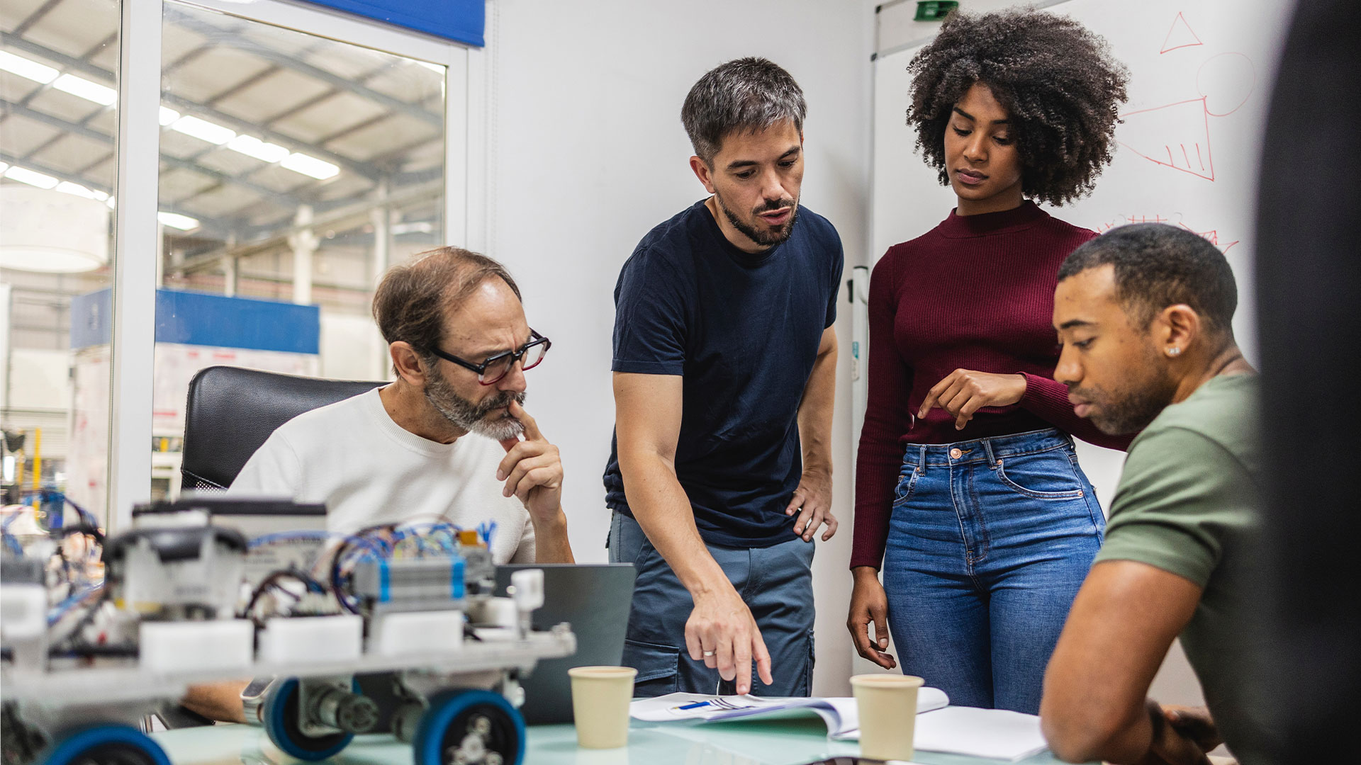 People in a meeting in industrial setting.