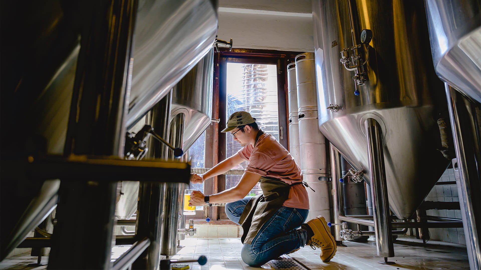 Man checking brewery product, beer manufacturing, brewery design, brewery construction