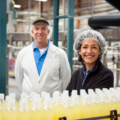 Male and female employee in a food and beverage factory