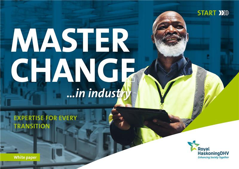 Manufacturing engineer in a uniform holding a tablet to monitor supply chain operation performance