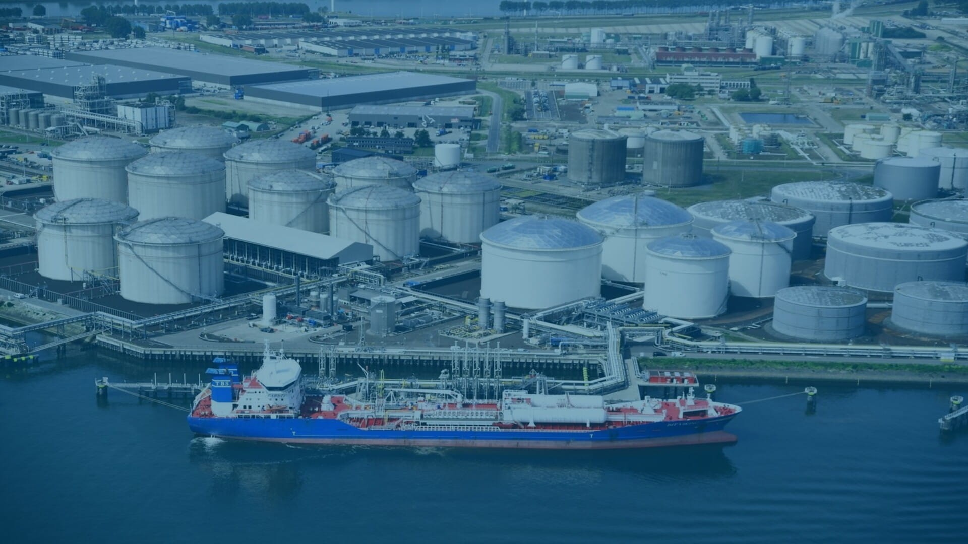 Aerial view of a port with a ship docked in front
