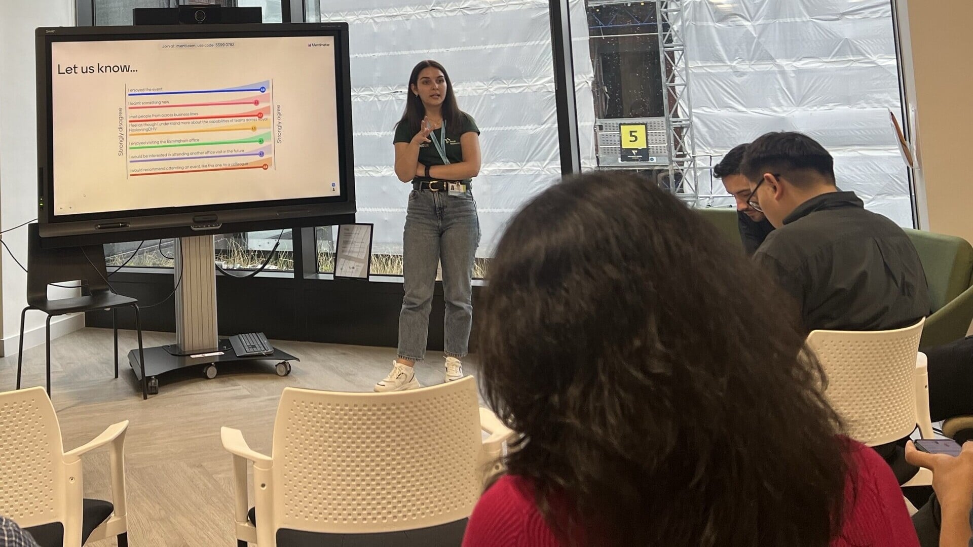 girl presenting in front of a crowd