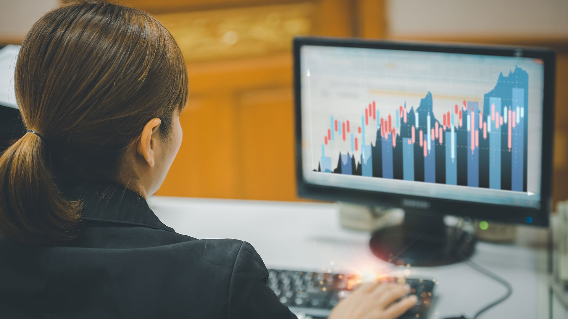 Woman looking at screen with data on it