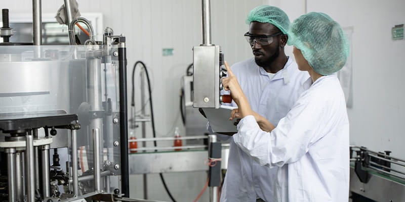 FMCG professionals in the manufacturing industry working on resolving sustainability challenges in their supply chain operations