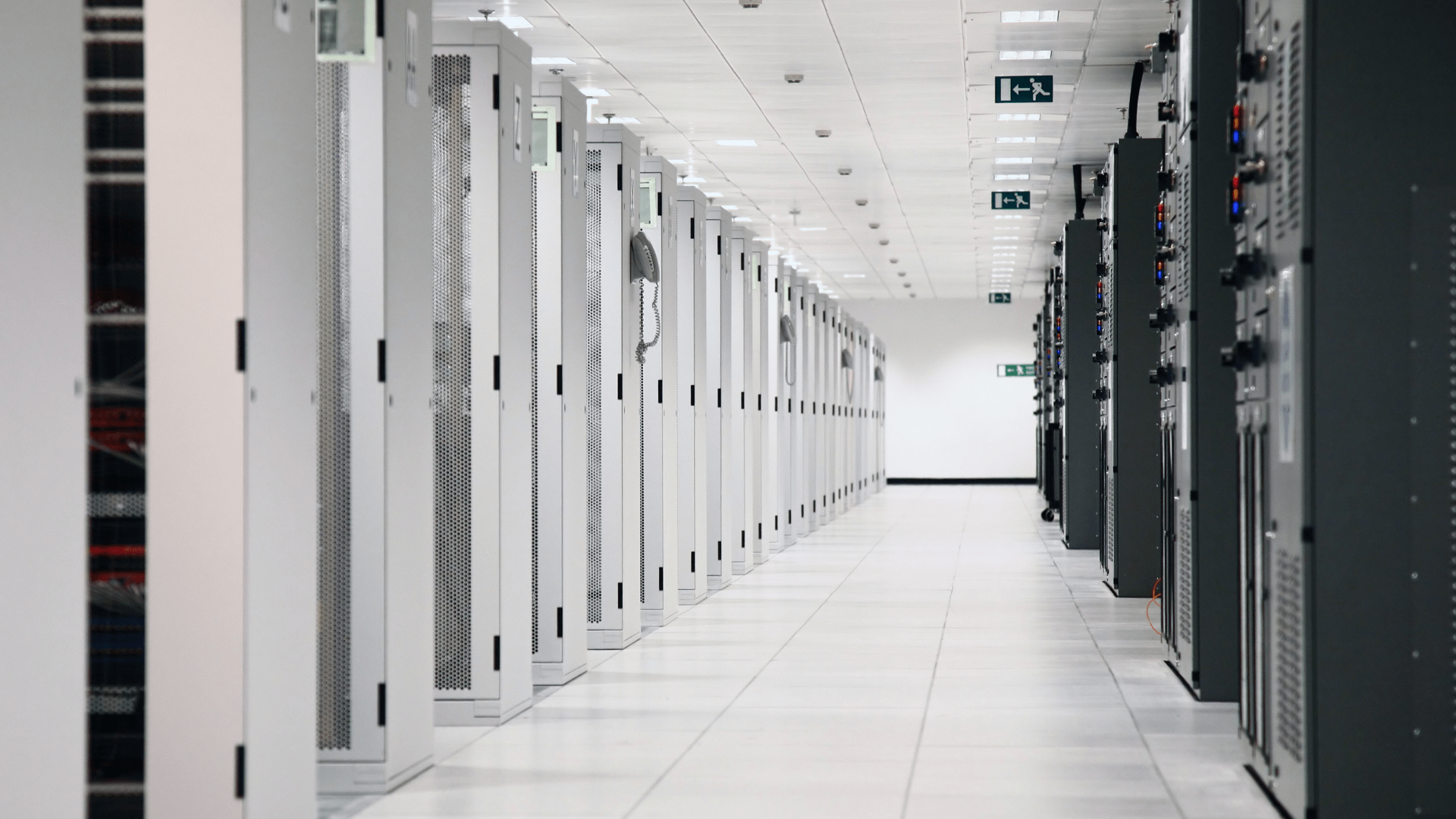 Long corridor of server racks inside a data centre, symbolising AI-ready digital infrastructure