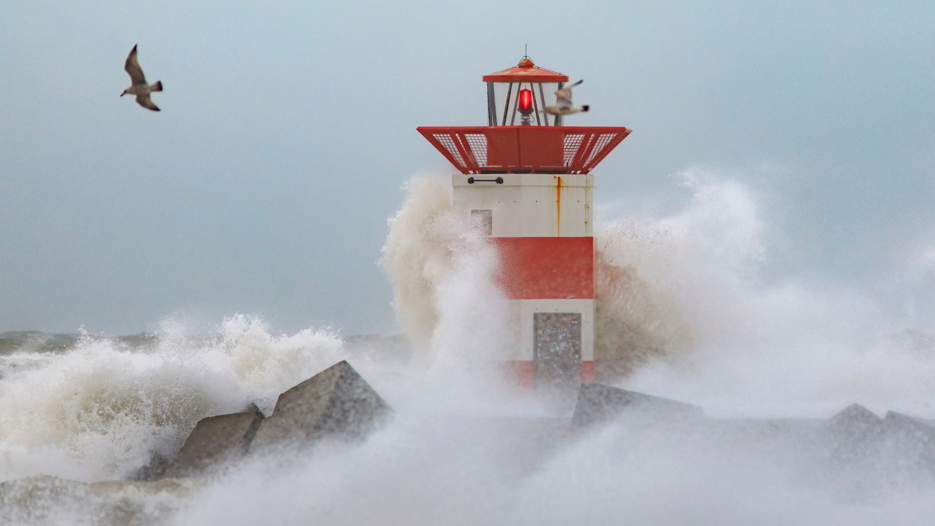 lighthouse during a storm with waves 