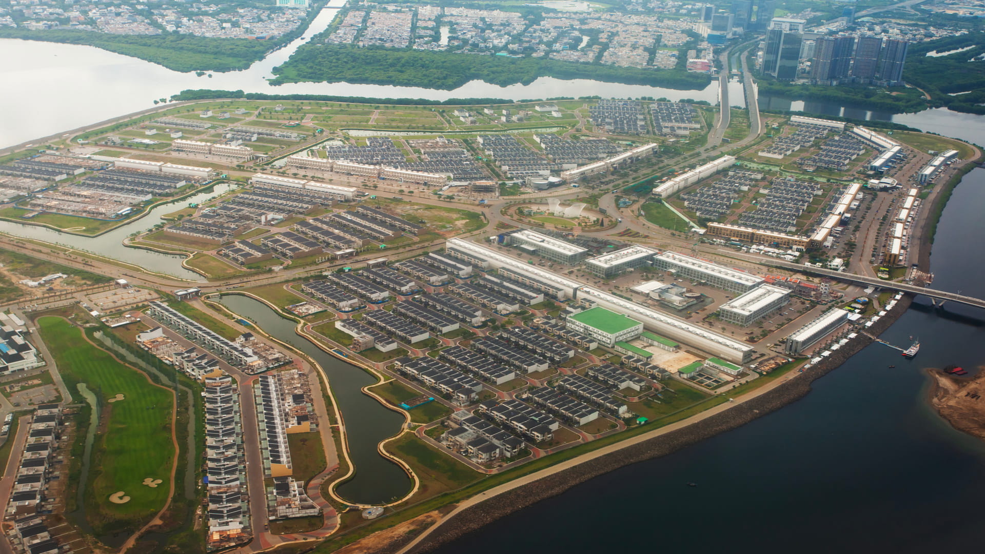 Aerial view showcasing a bustling industrial area within an urban landscape, highlighting factories and warehouses.