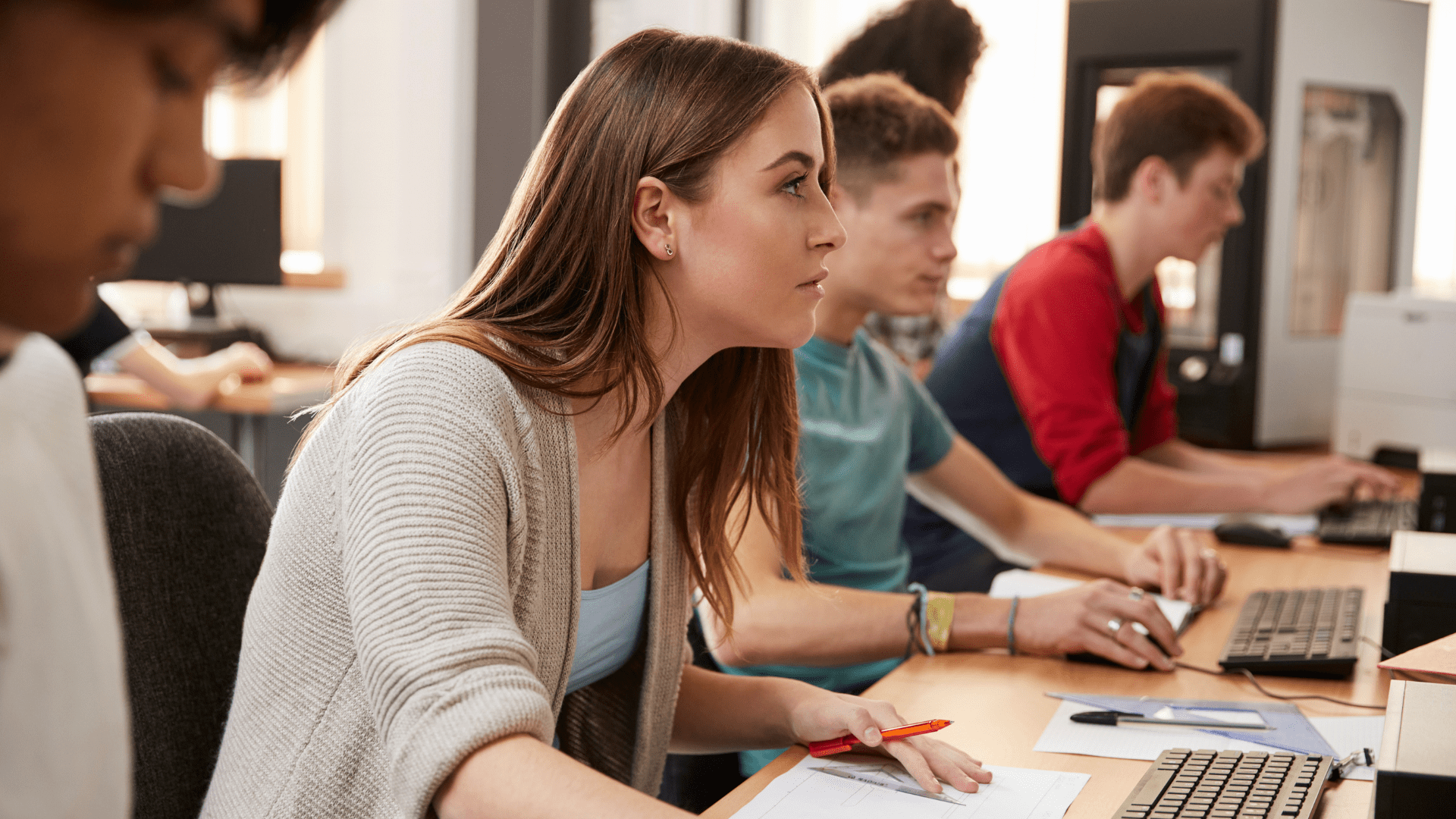 Students work in a college computer lab on a Witness simulation software assignment