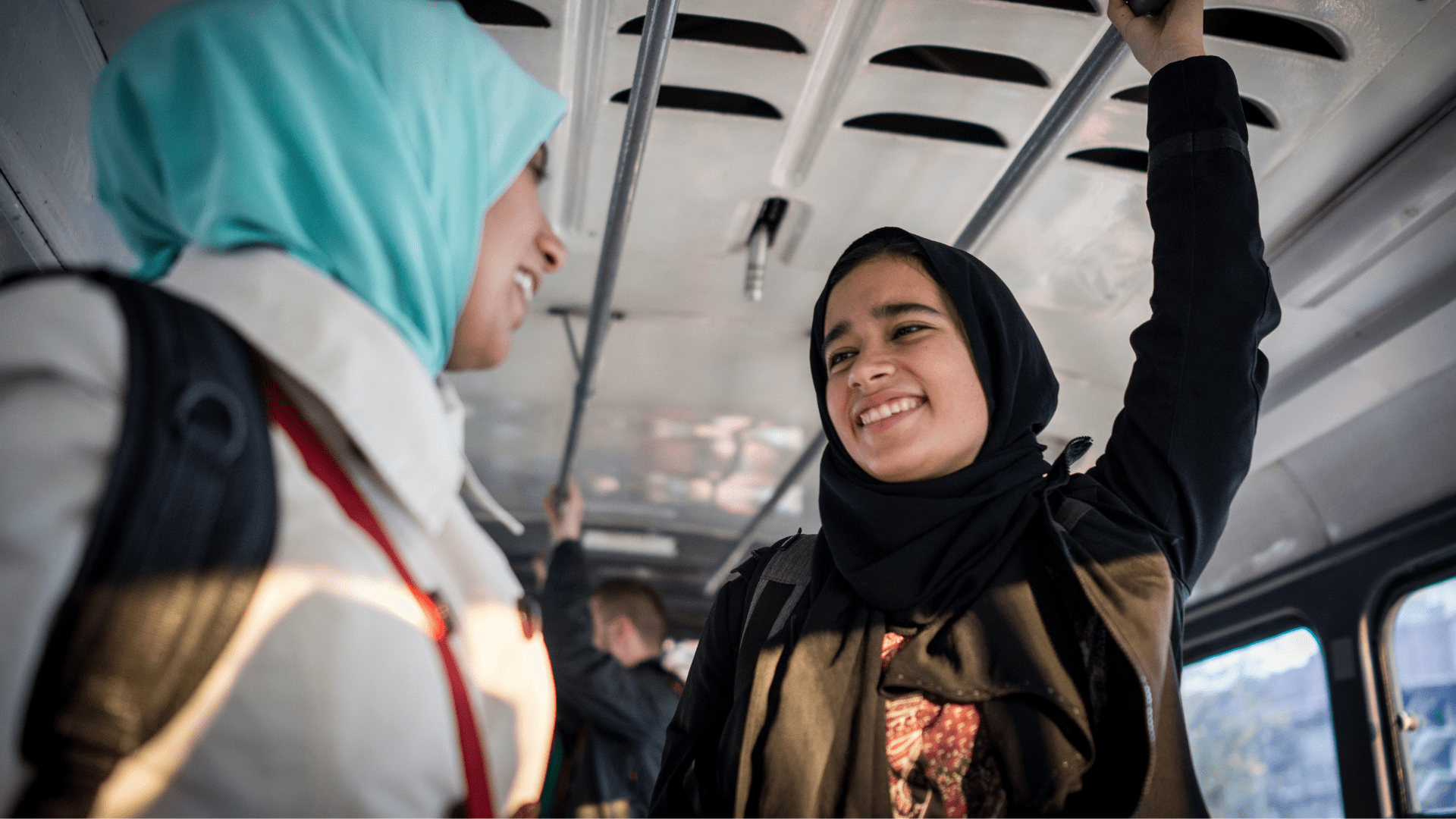 Two women are taking the bus