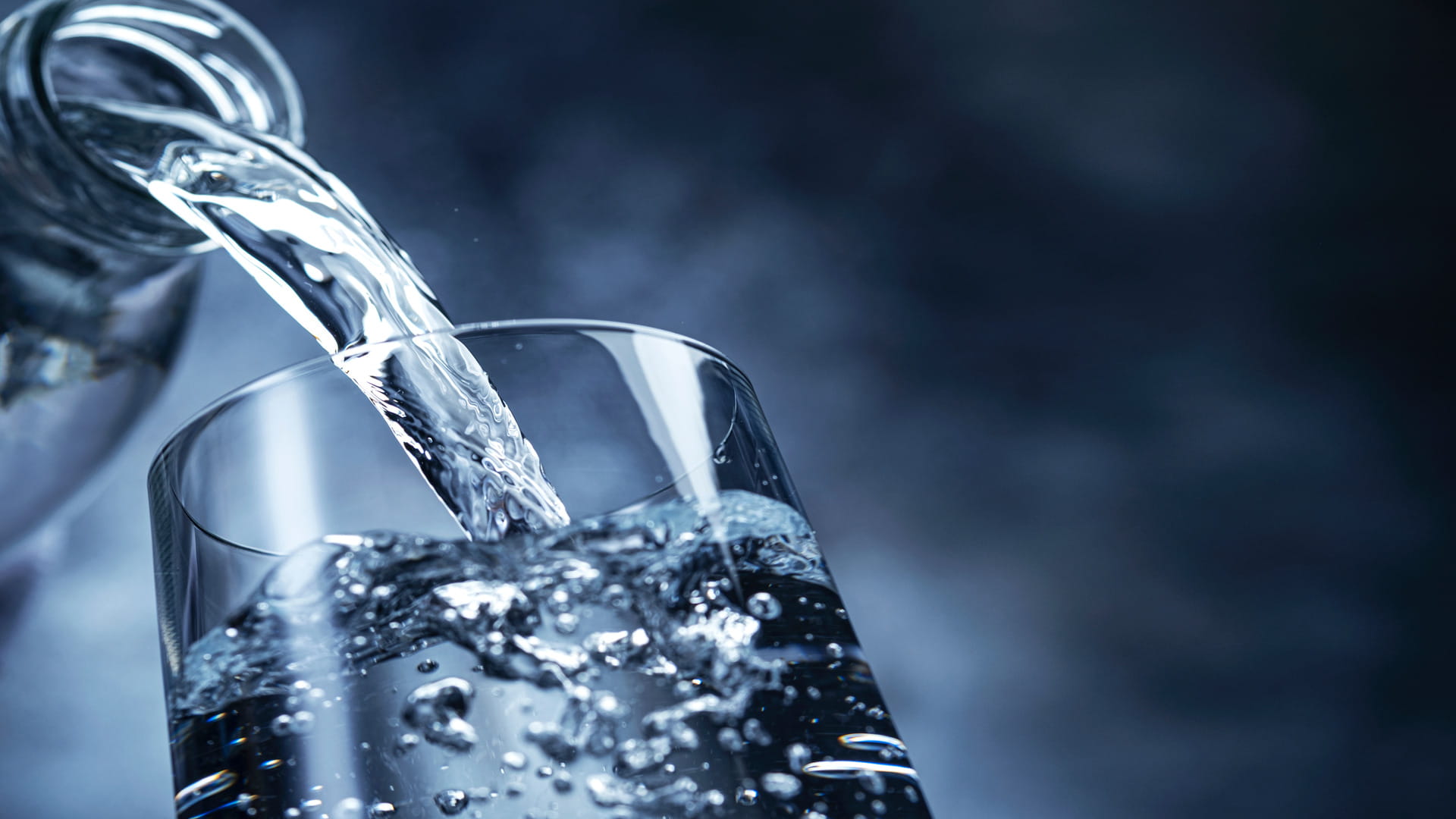 Fresh water being poured into a glass, highlighting challenges with PFAS in drinking water and the importance of PFAS management, PFAS treatment, drinking water quality protection, and advanced PFAS removal technologies within modern water treatment solutions.