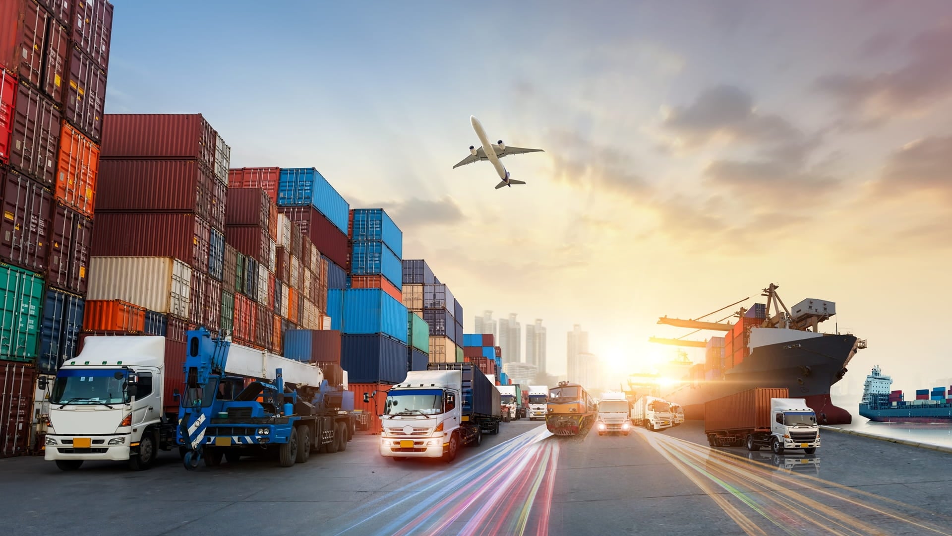 Multimodal domestic logistics with container stacks, cargo trucks, a container ship and an aircraft, illustrating truck–ferry corridors beyond traditional TEU‑based container throughput.