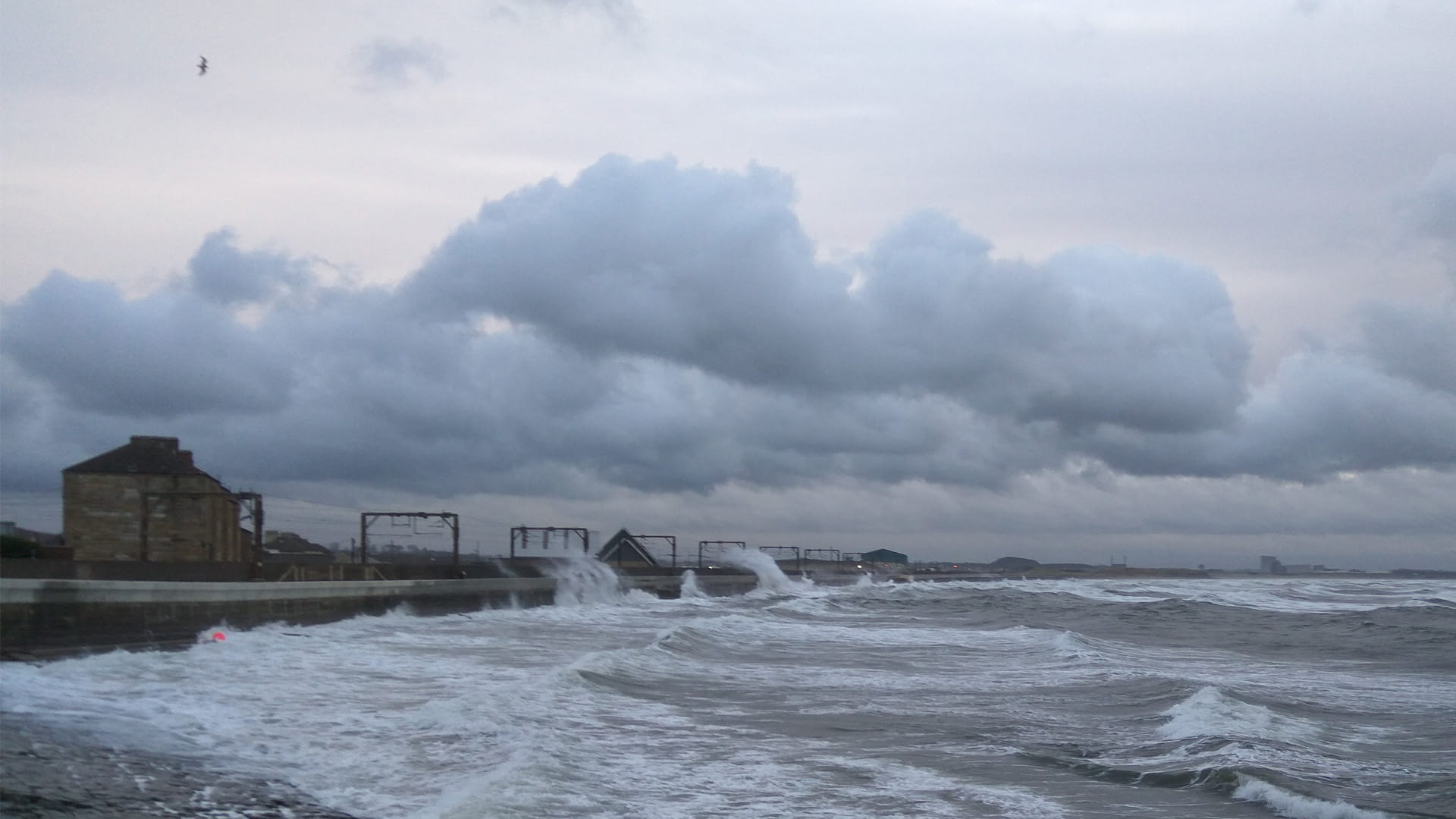 waves crashing onto the coast in the UK