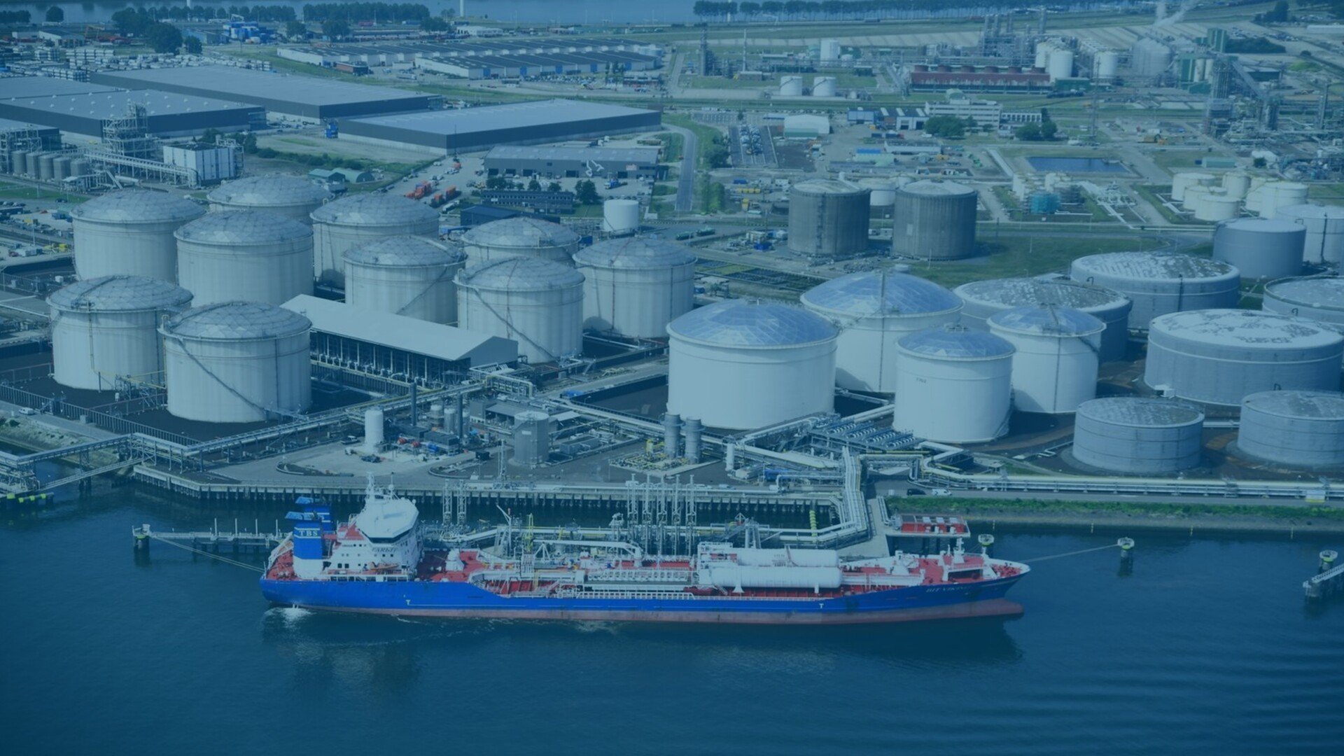 Aerial view of a port with a ship docked in front