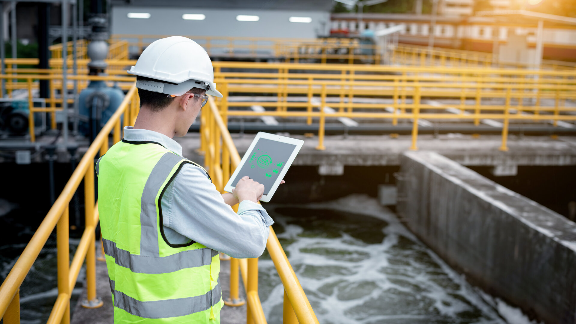 An engineer working in a water utility monitors N2O emissions with the use of AI-based technology.