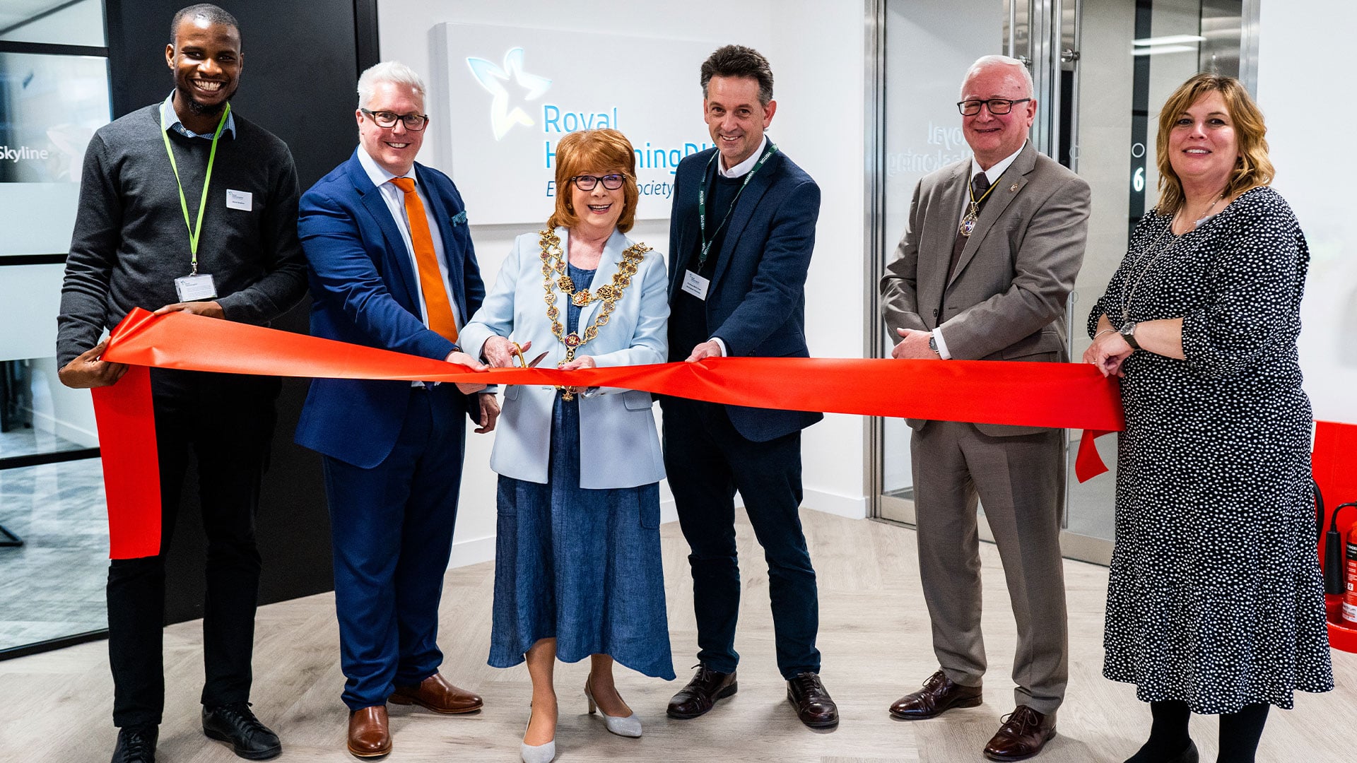 people cutting a ribbon symbolizing the opening of a new RoyalHaskoningDHV office in Birmingham UK