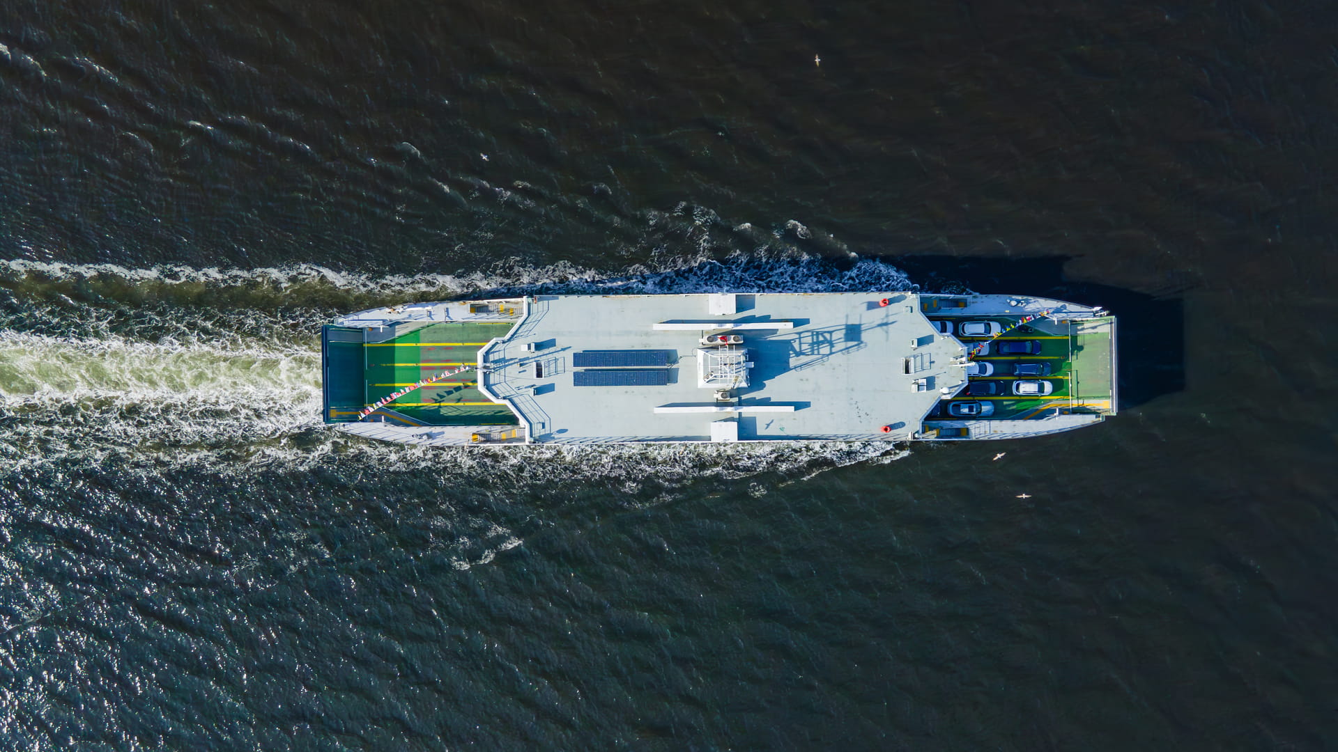 Passenger and vehicle ferry boat cruising between islands in sea. Sea logistics and transportation.