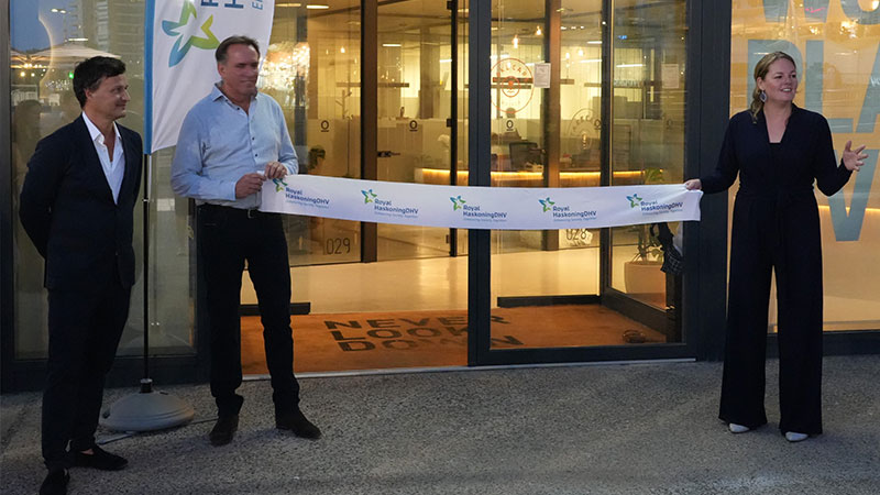 Three people with ribbon for office opening Spain