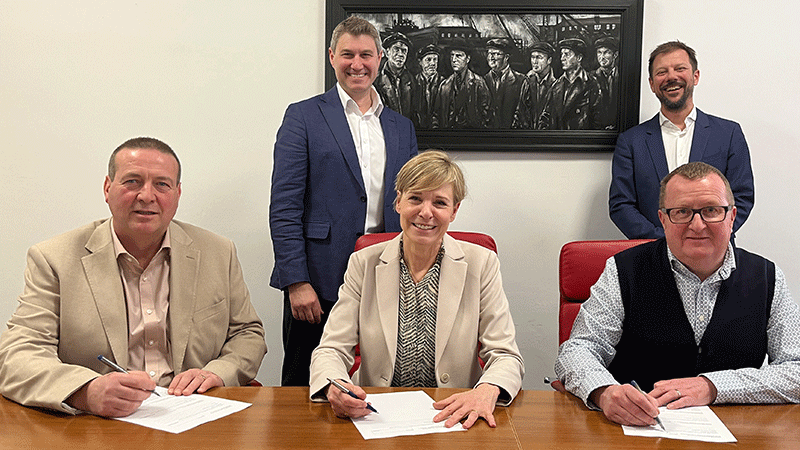 Signing moment with Arch Henderson