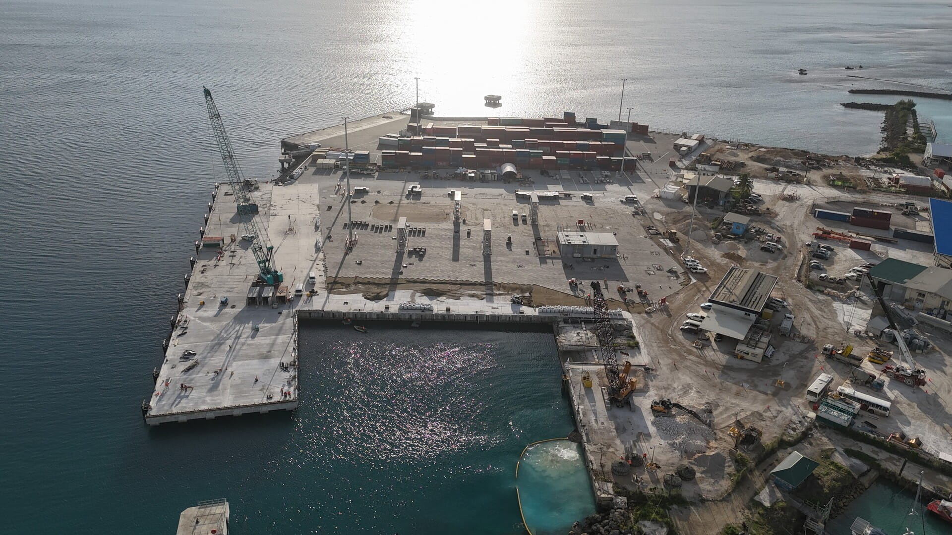 Upgraded port in Tonga with extended wharf and container stacks, enhancing maritime infrastructure capacity.