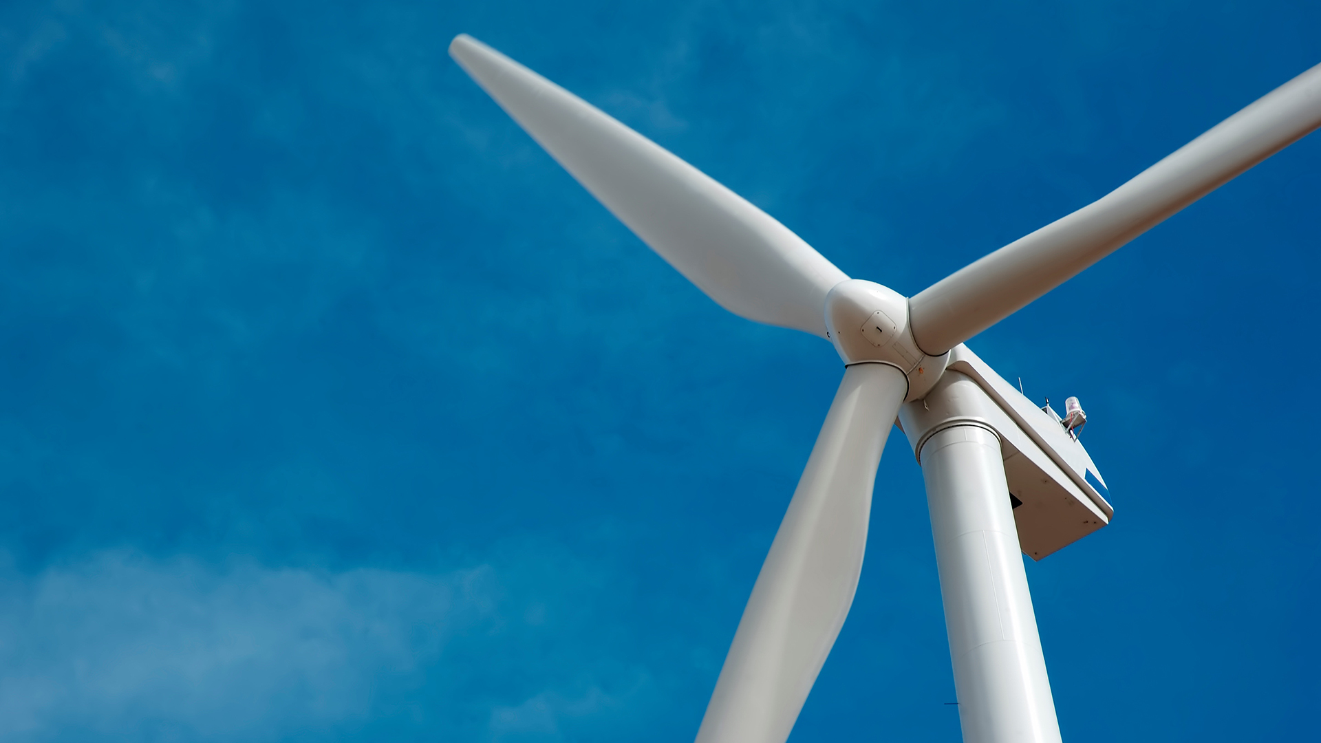 Offshore wind turbine with a clear blue sky