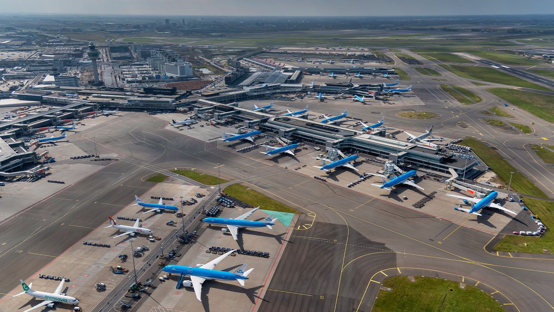 Aerial view of Schiphol Airport, showcasing the new future-proof architecture of a terminal and pier.