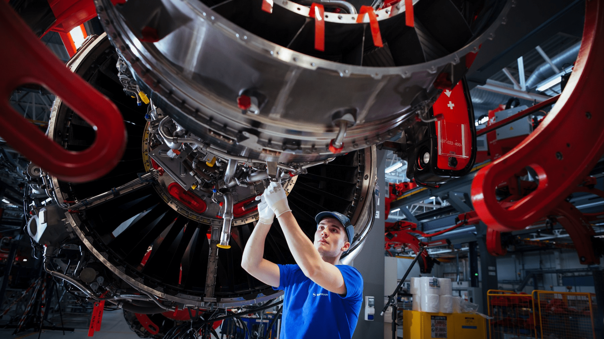 A mechanic works on an airplane at a Safran facility