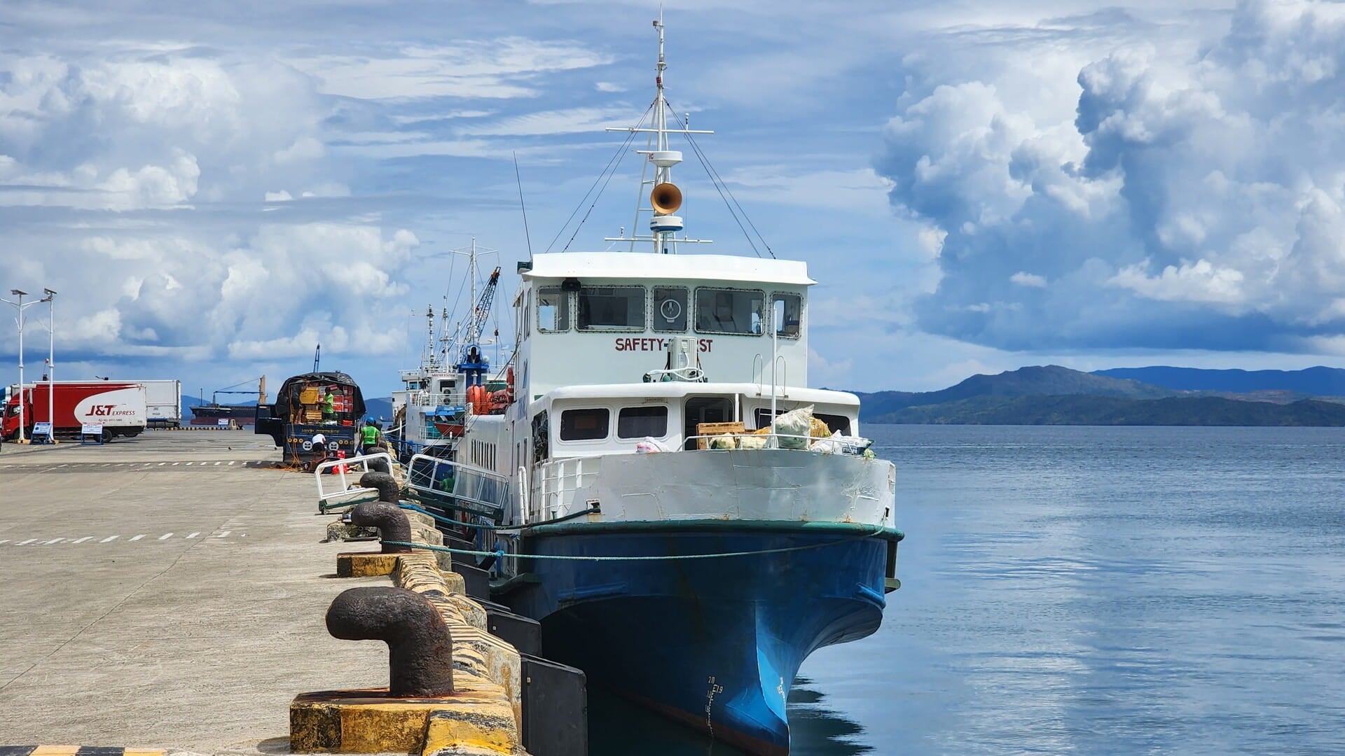 A passenger and cargo ferry docked at a Philippine port under a blue sky, illustrating maritime connectivity and port development infrastructure in the Philippines
