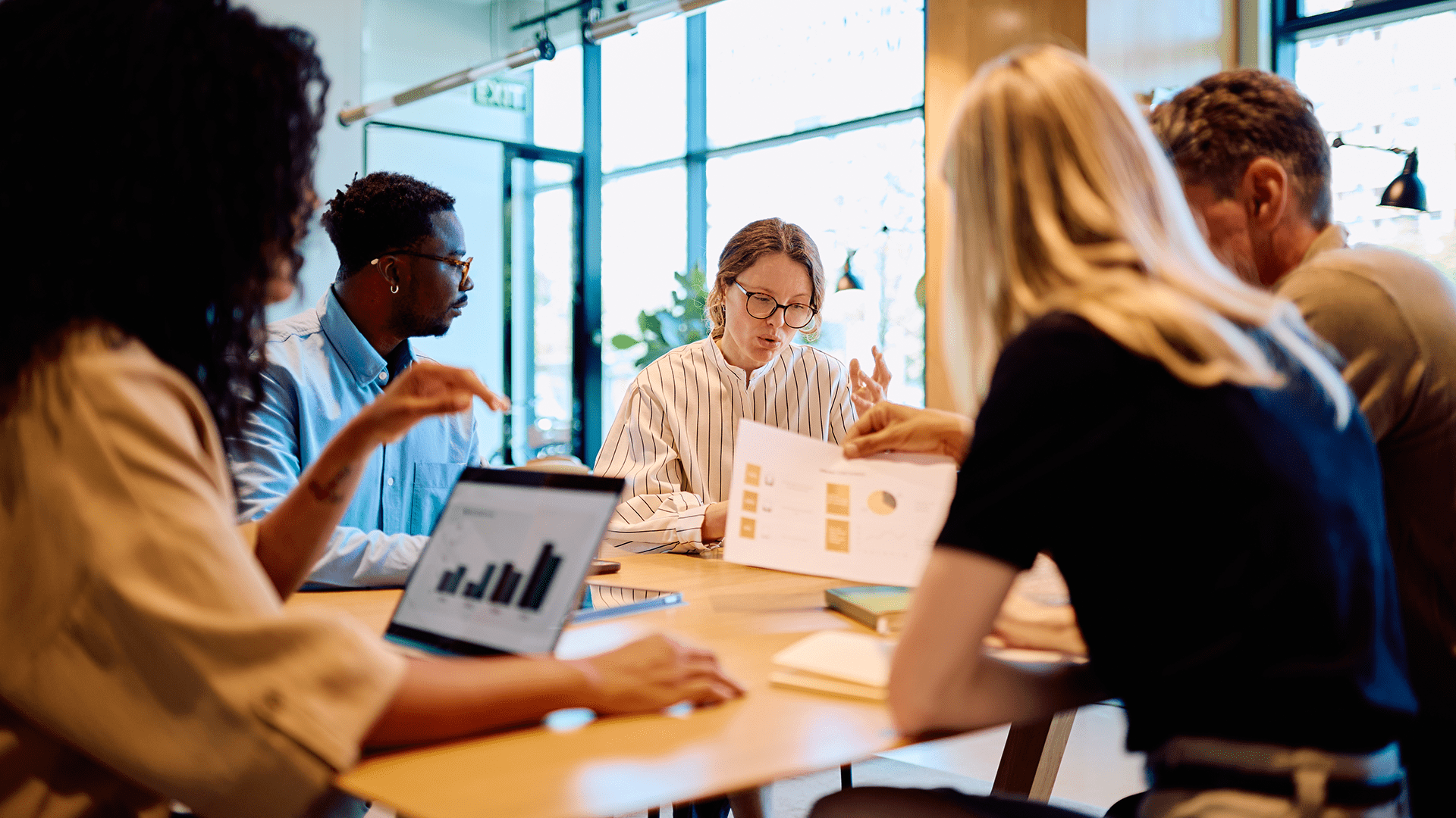 Group of colleagues working at a table in an office space