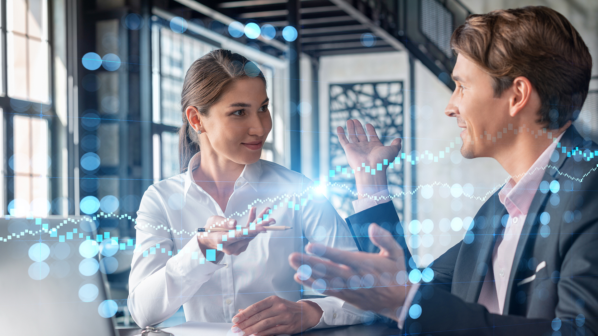 Two professionals discussing digital services in an office with a digital overlay on the