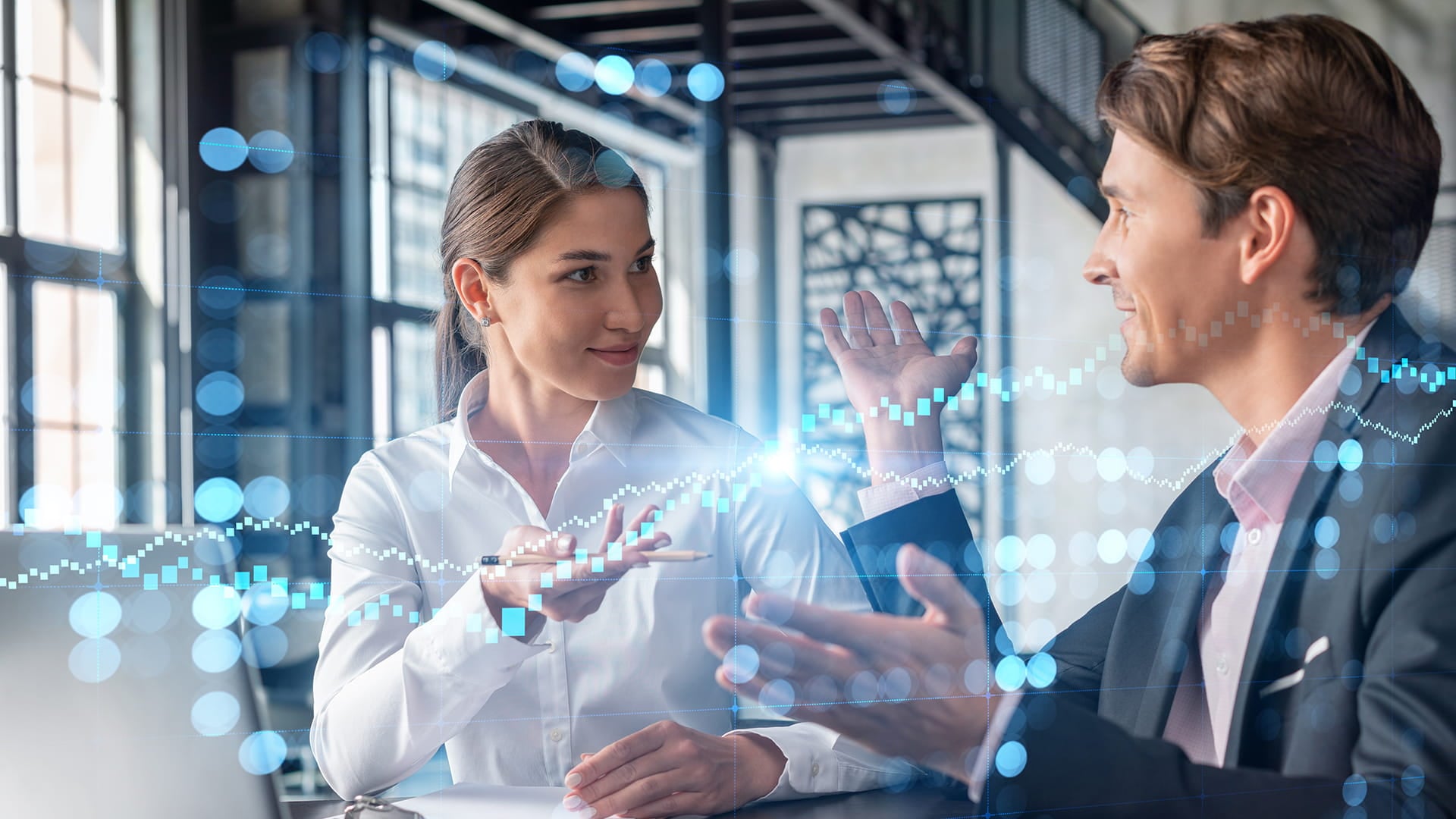 Two professionals discussing digital services in an office with a digital overlay on the