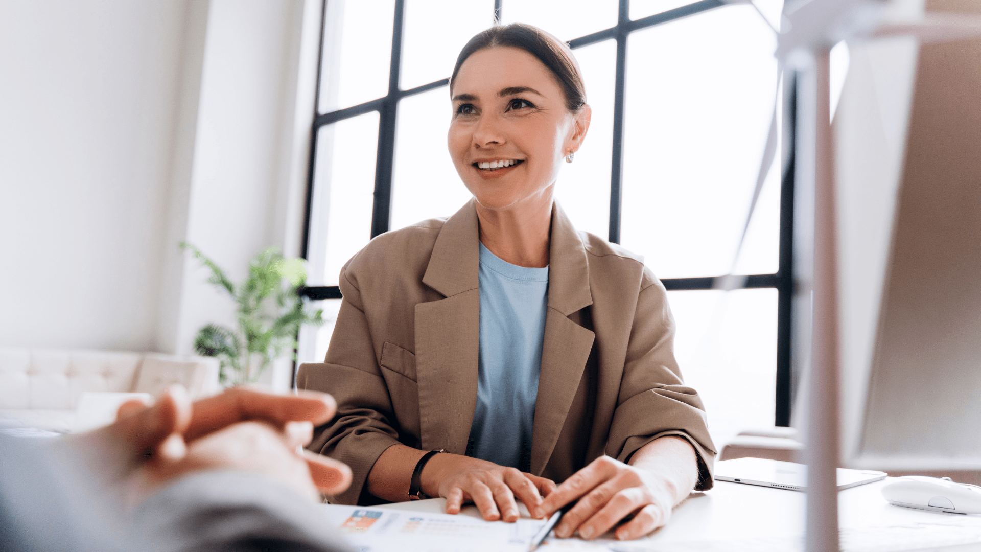 Woman at a desk, smiling