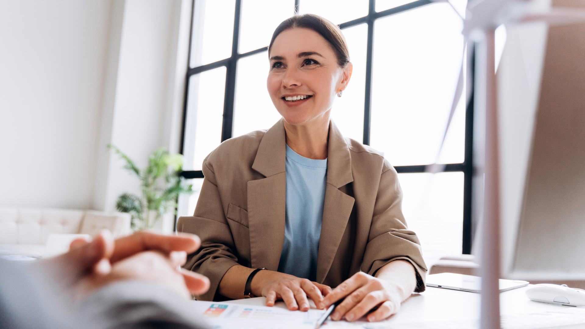 Woman at a desk, smiling