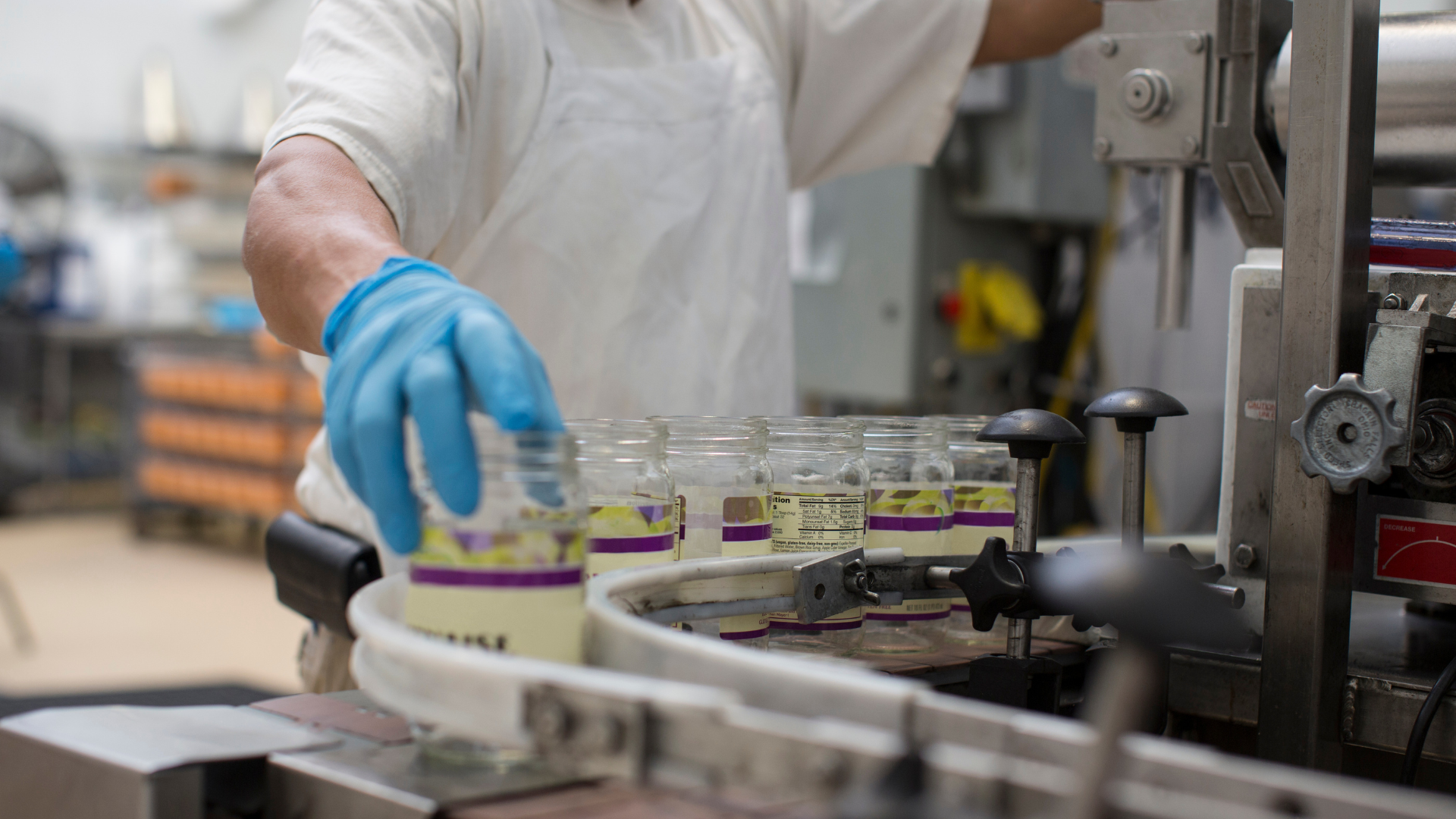 Operator in European food manufacturing facility managing packaging line to ensure operational efficiency and quality standards