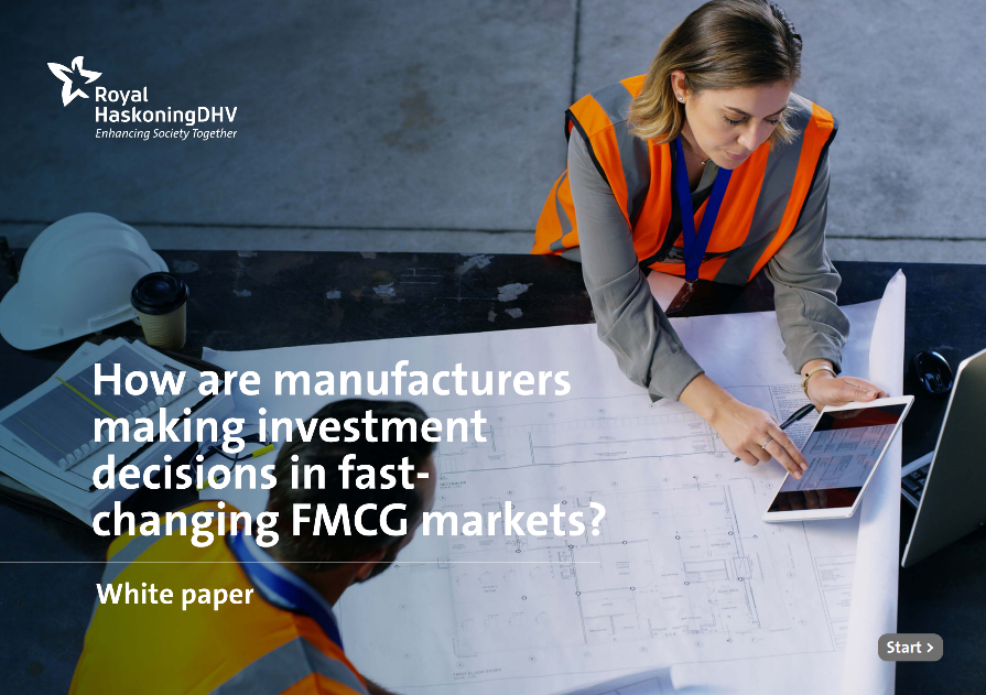 A woman and a man discussing business case consulting while wearing safety vests at a table, emphasizing their focus on strategy consulting and project management in a collaborative environment