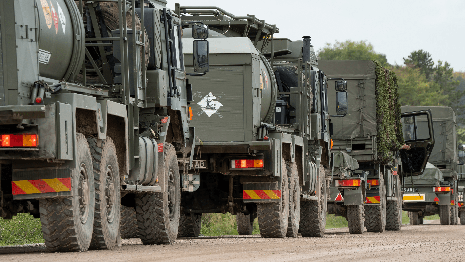Military vehicles lined up on the road