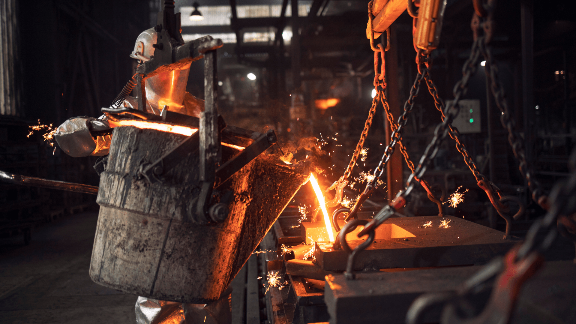 Worker pouring hot metal liquid