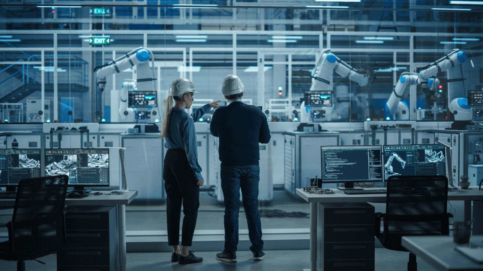 Two engineers observe factory operations
