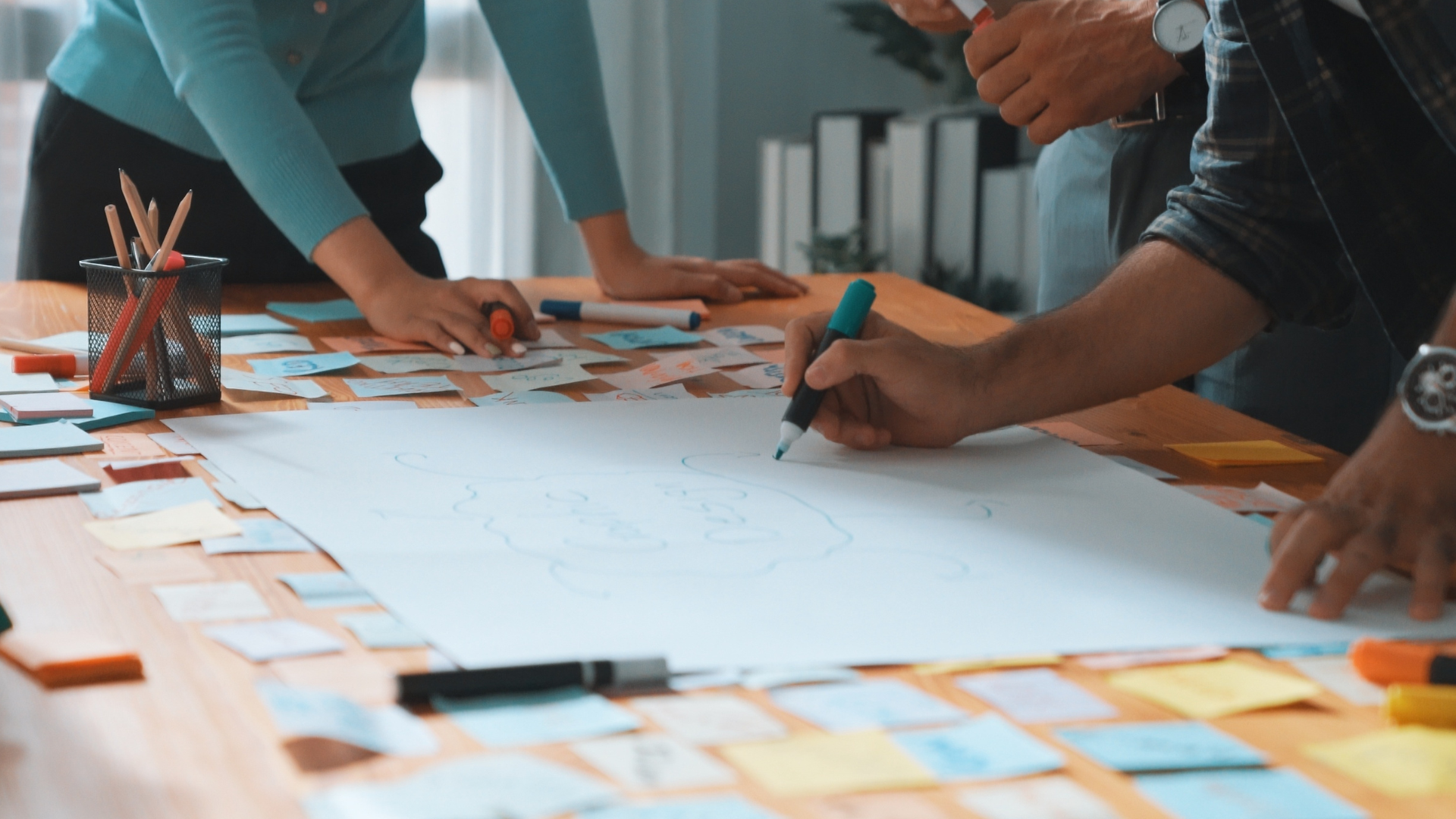 A team working out a problem on a large table