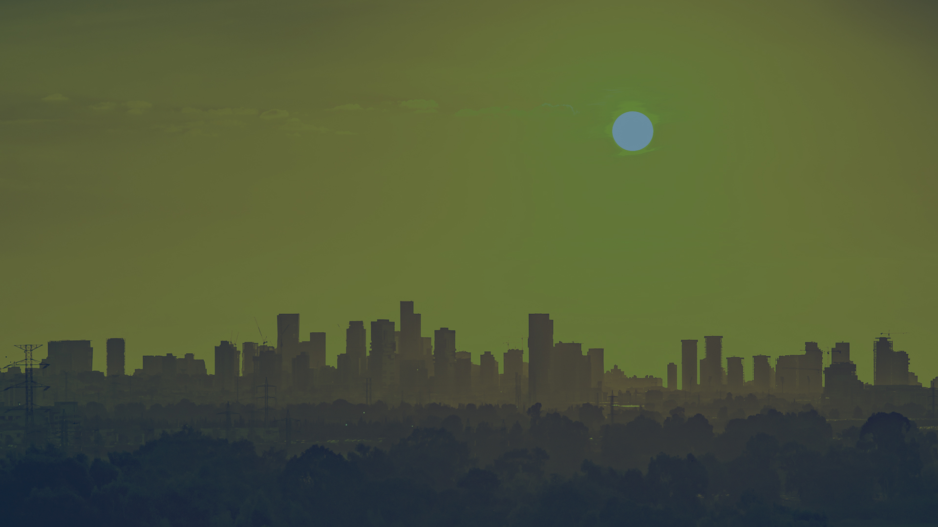 skyline panorama of a city bathed in sunshine on a hot day