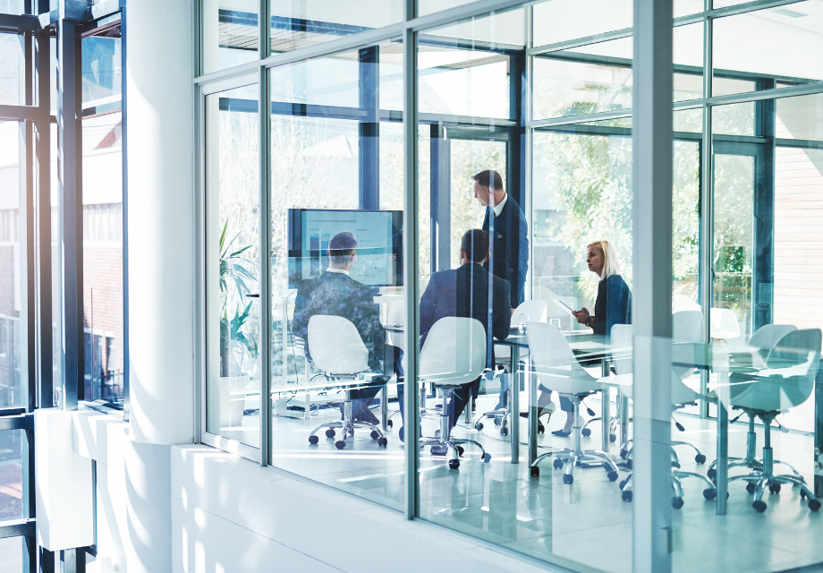 A director presents results to stakeholders in a boardroom