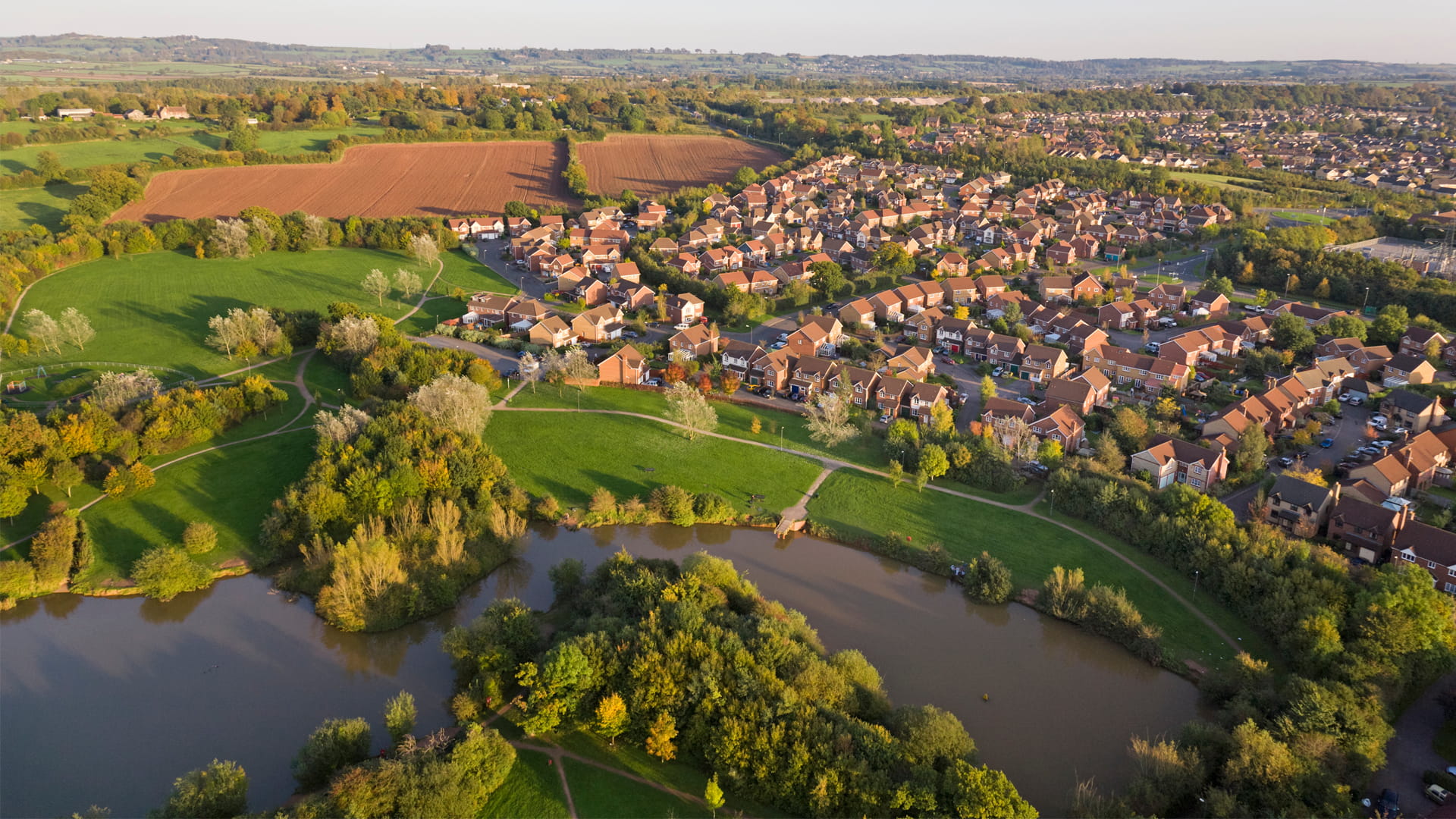 aerial view of a housing estate by a river