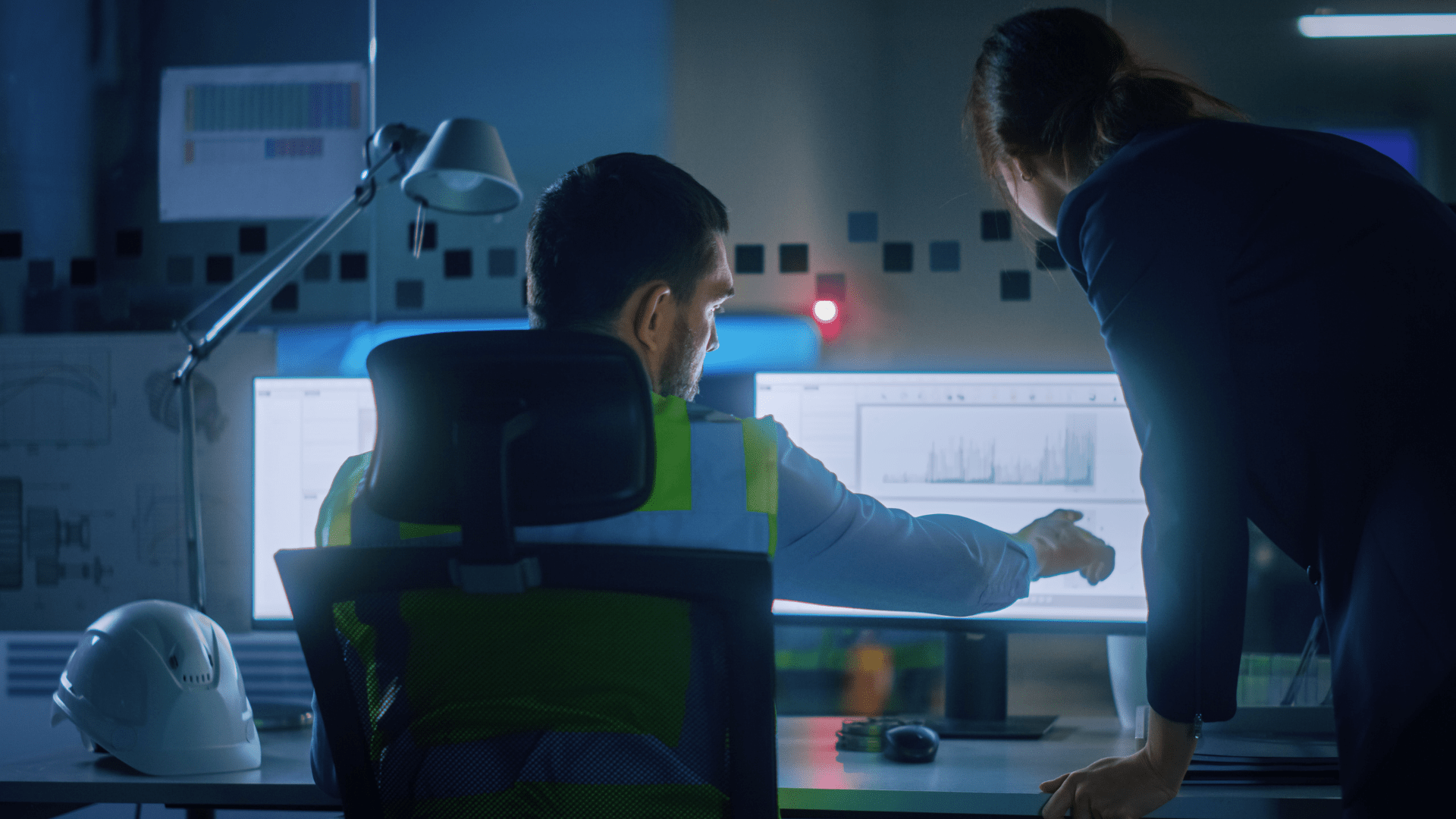 Two engineers looks at analysis from a simulation model on a computer screen